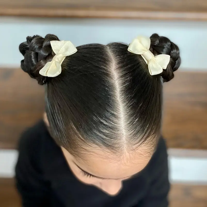 Double Braided Buns with Bow Accents Hairstyle